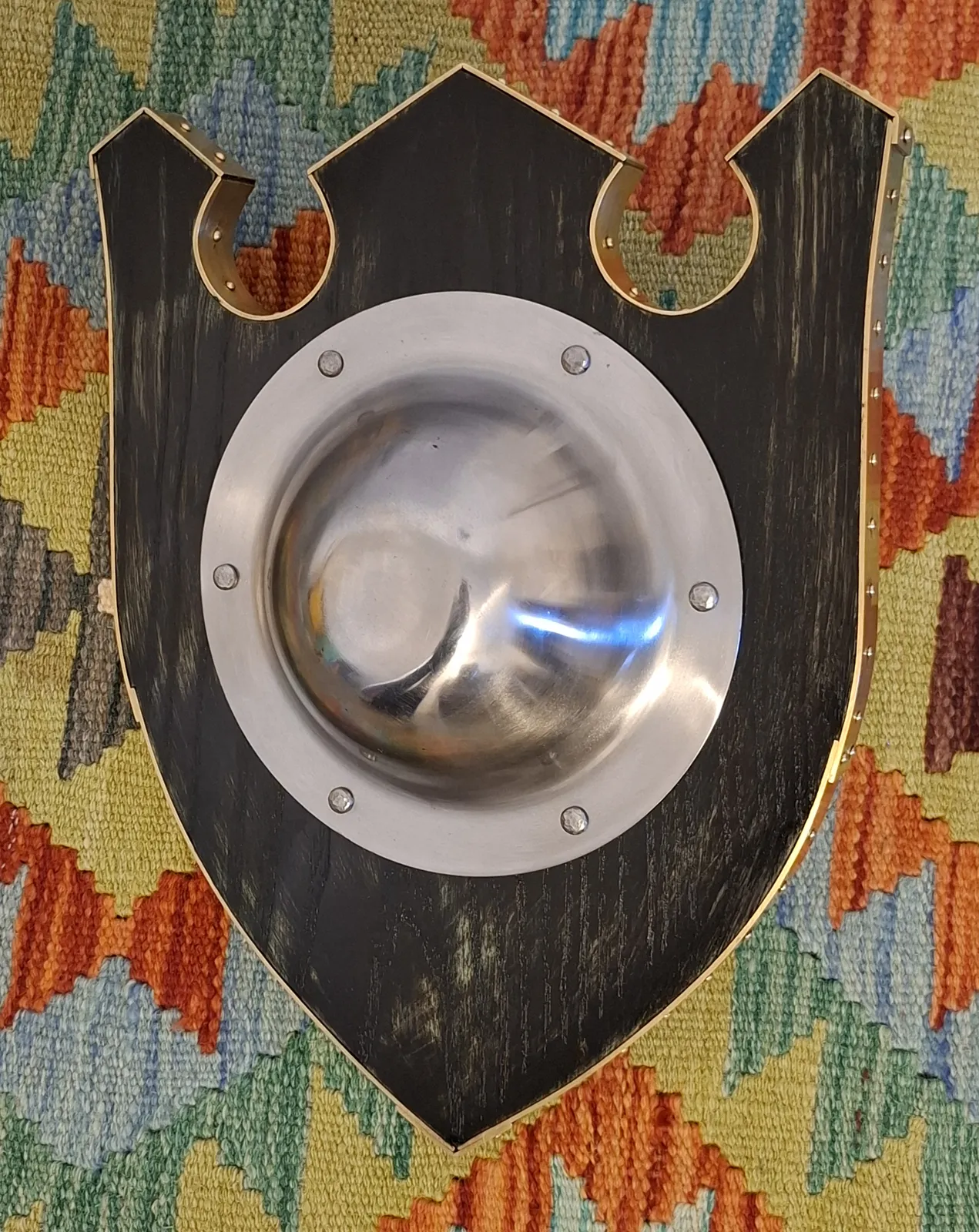 George's shaped buckler in dark wood with a steel boss and a riveted brass edge