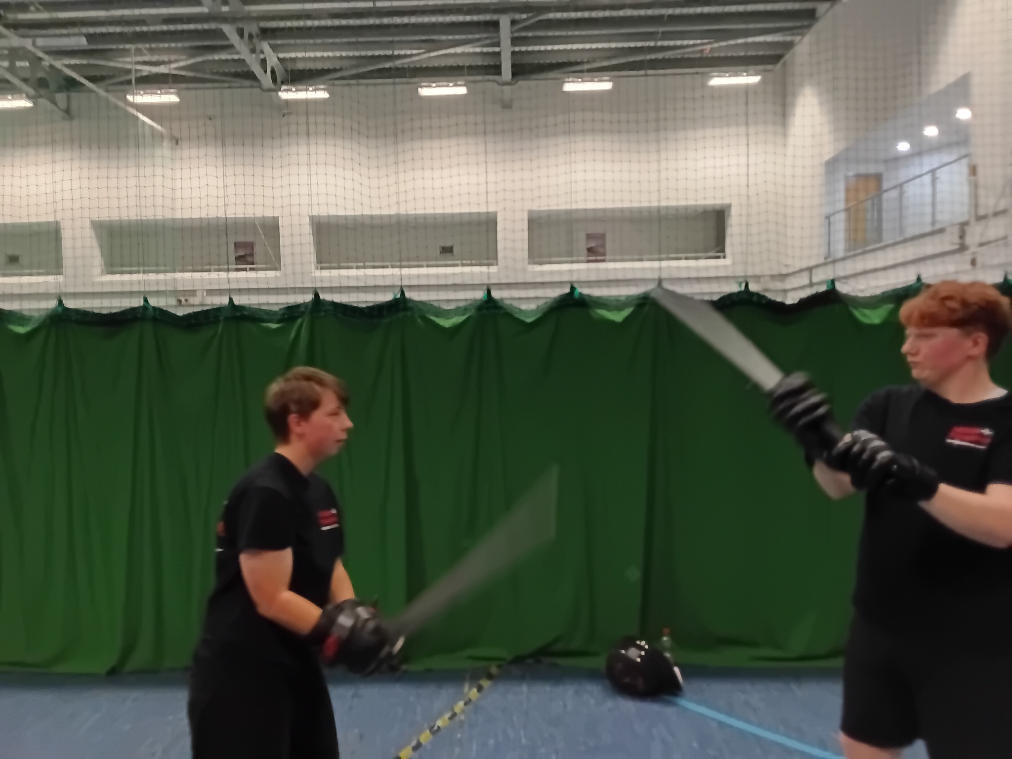 Two members sparring with blade motion blur