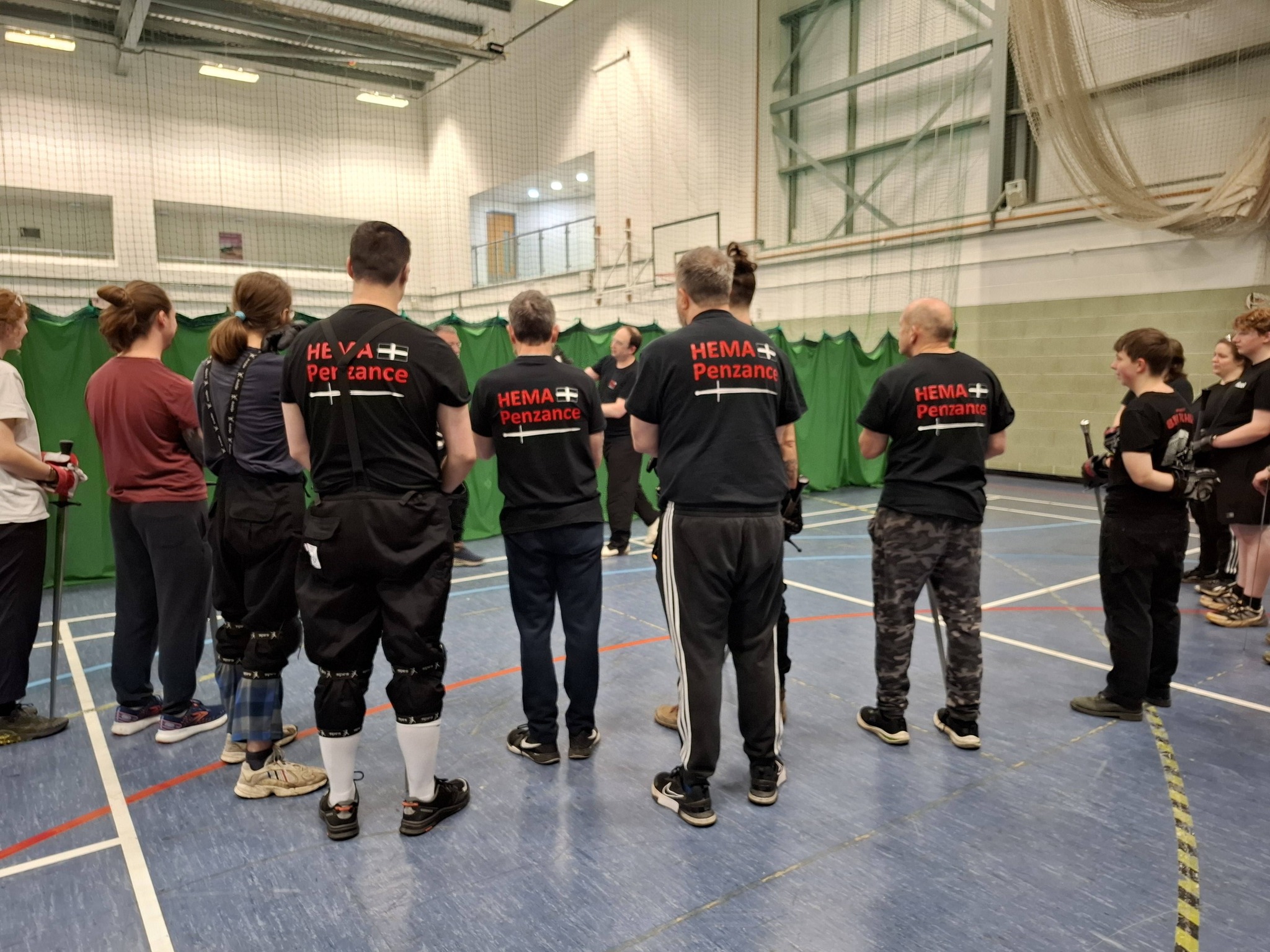 Members in HEMA Penzance t-shirts gathered in the hall