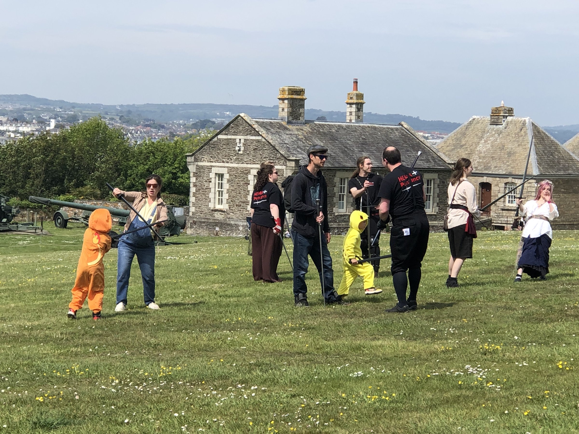 HEMA Penzance members chatting with costumed festival-goers on the castle grass at FABLEFUSION