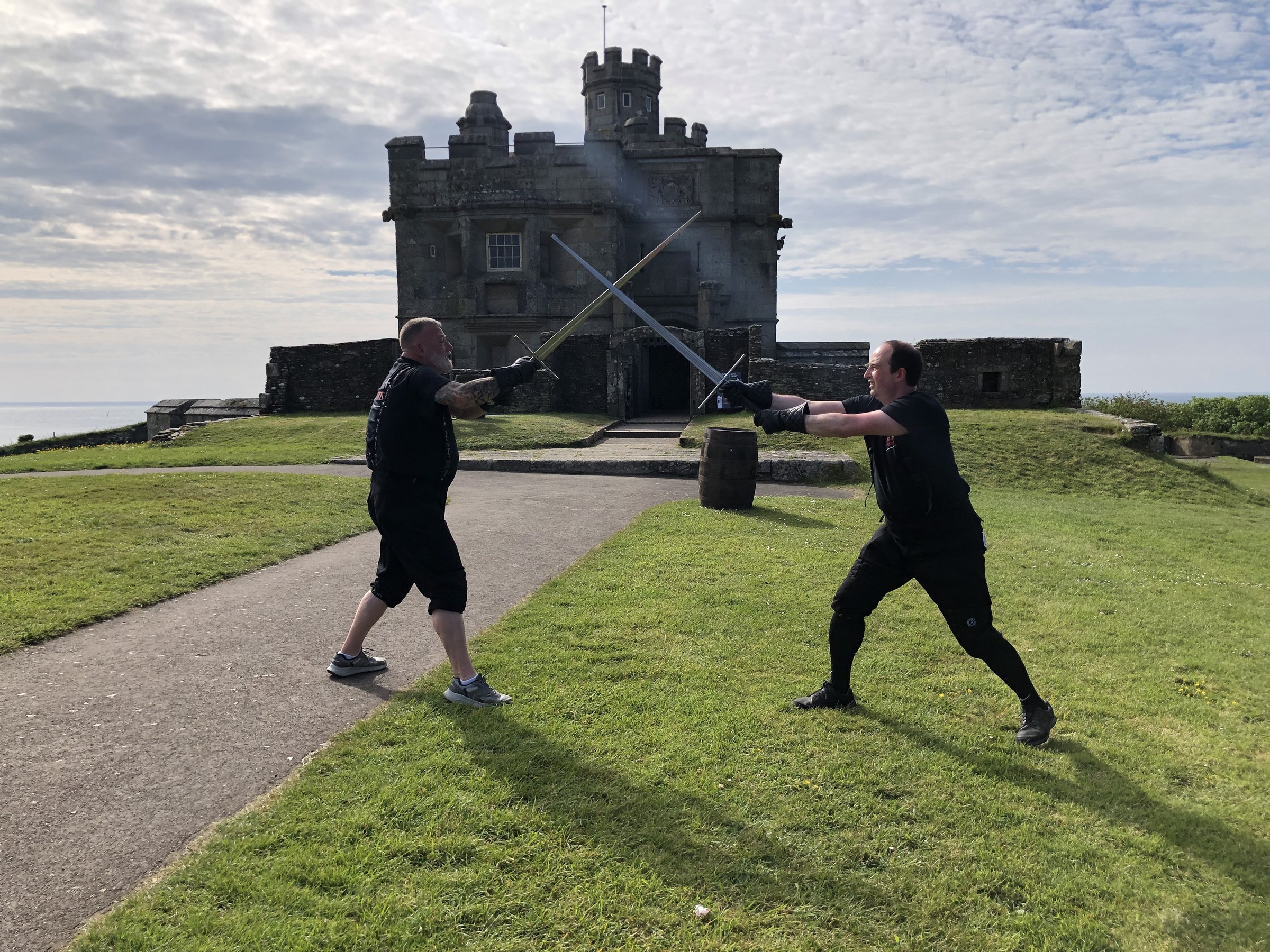 HEMA Penzance members sparring with longswords below the Pendennis Castle keep