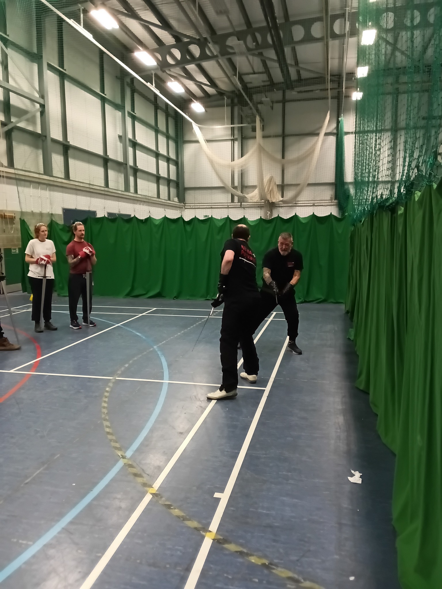 Sparring with longswords while others observe